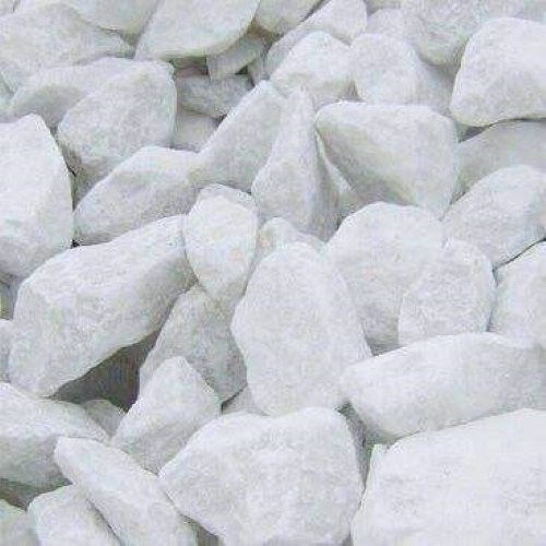 Close-up view of white limestone rocks used as a key ingredient in cement production.