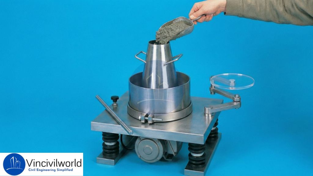 A person pouring a scoop of material into a metallic measuring cone on a balance scale, with a blue background.